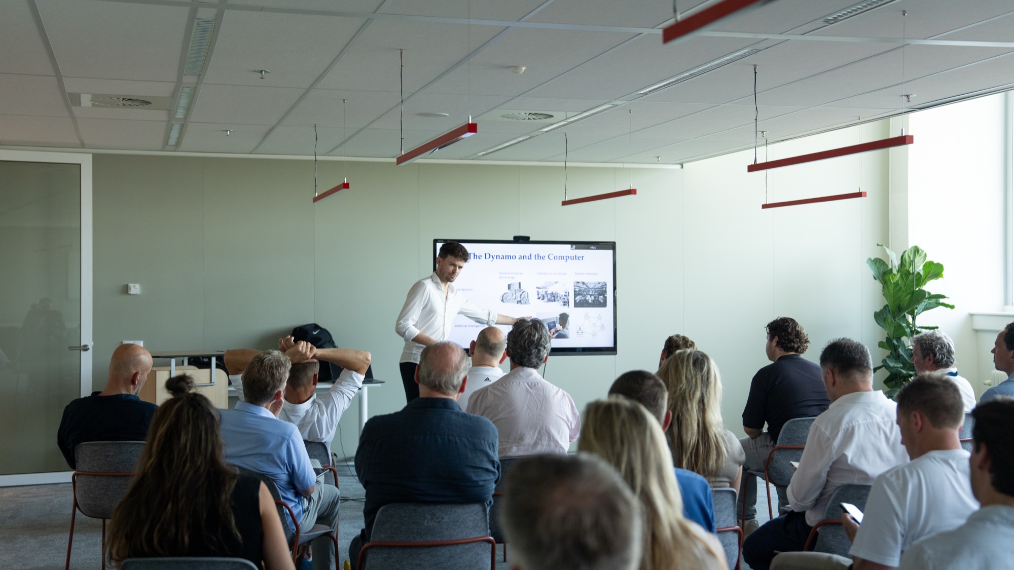 Wesley giving a keynote on The Dynamo and the Computer to a business audience at an AI and sport event